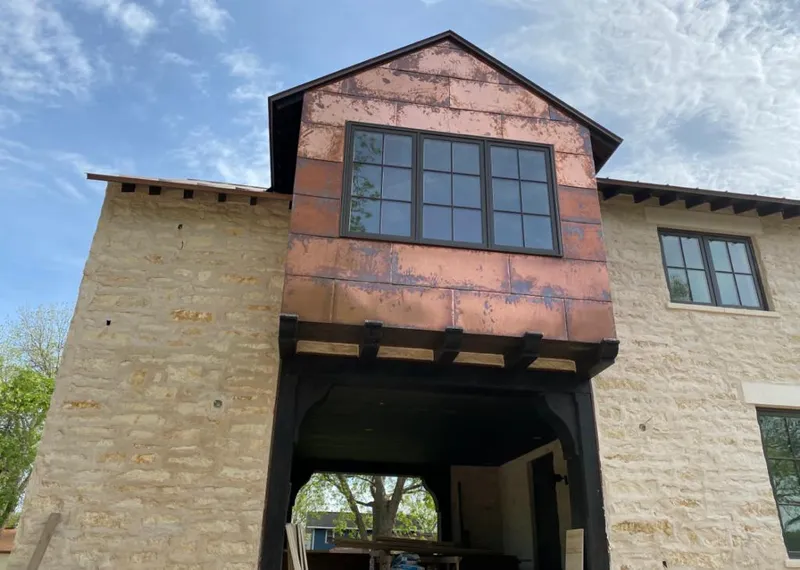 Copper metal panel facade on a stone building for Roof Repair in Tallmadge