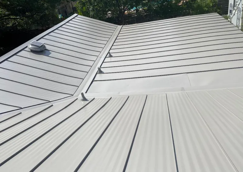 Solar attic fan installed on a metal roof for Roof Ventilation in Tallmadge